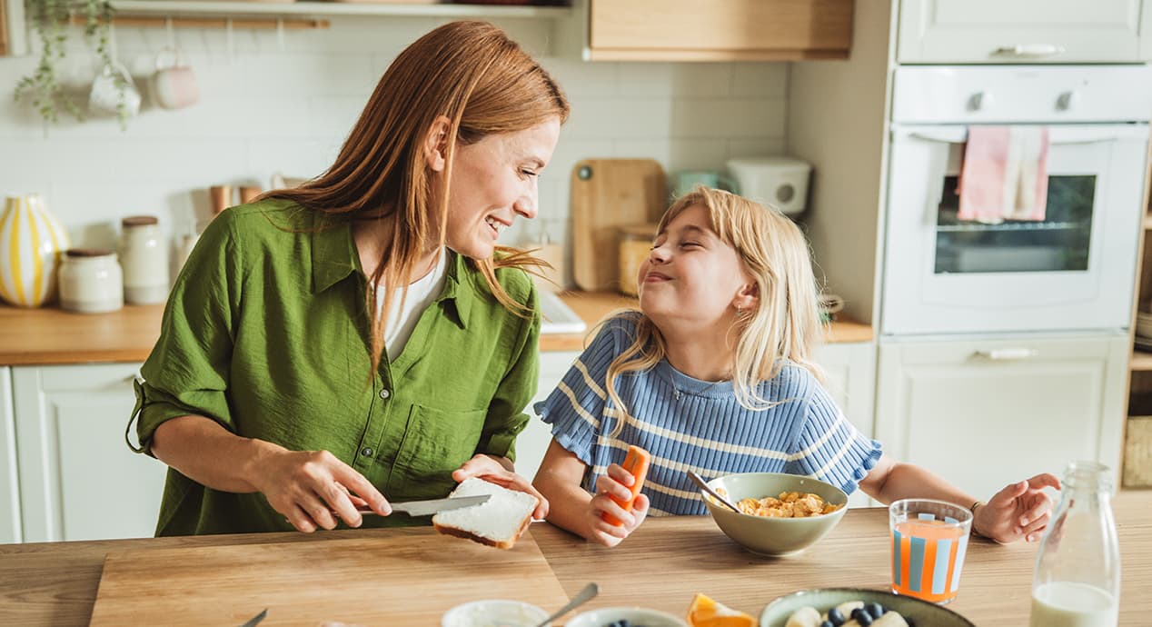 Mother Preparing Healthy Meal For Her Daughters In The Morning